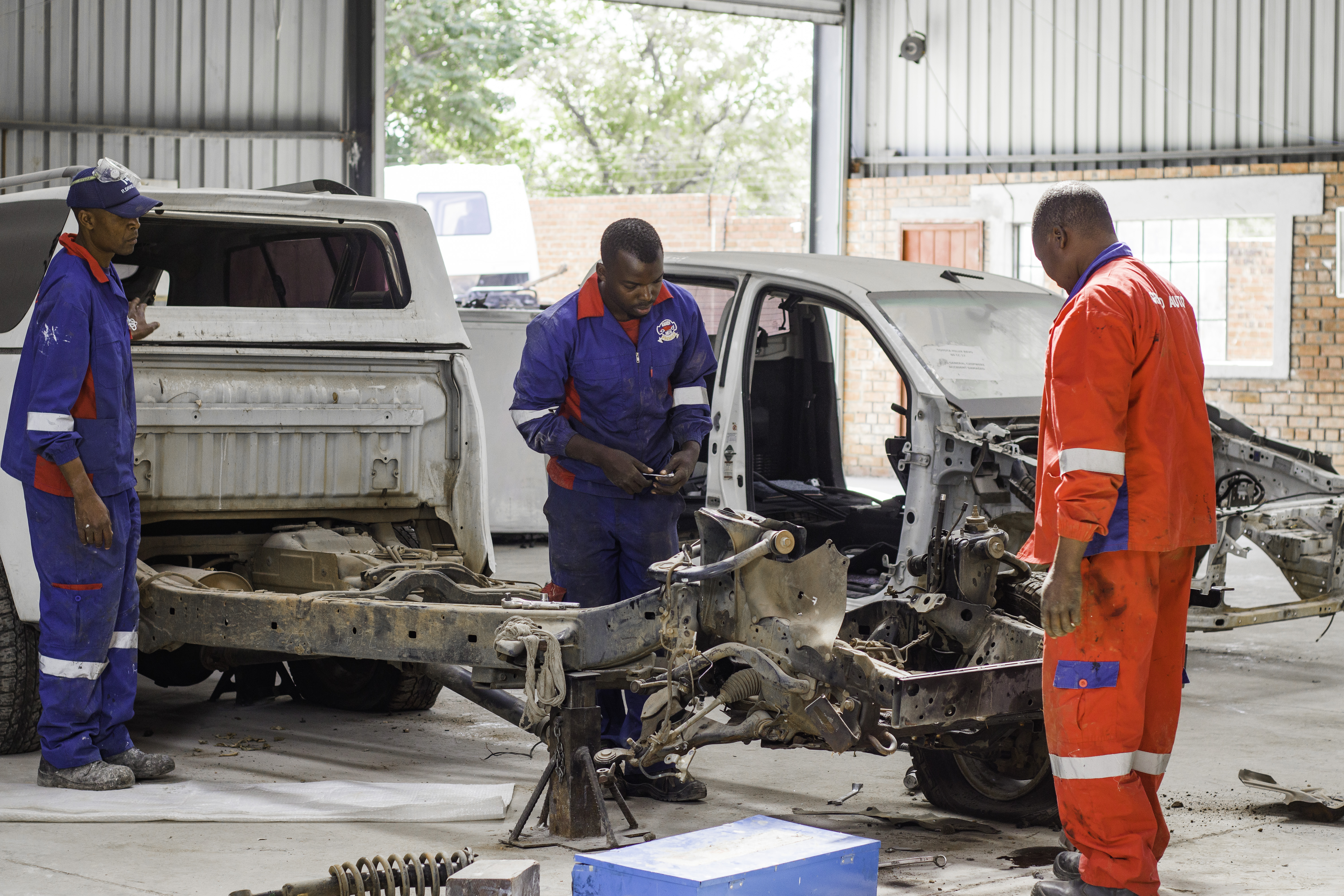Grand Auto Premier technicians rebuilding a vehicle chassis